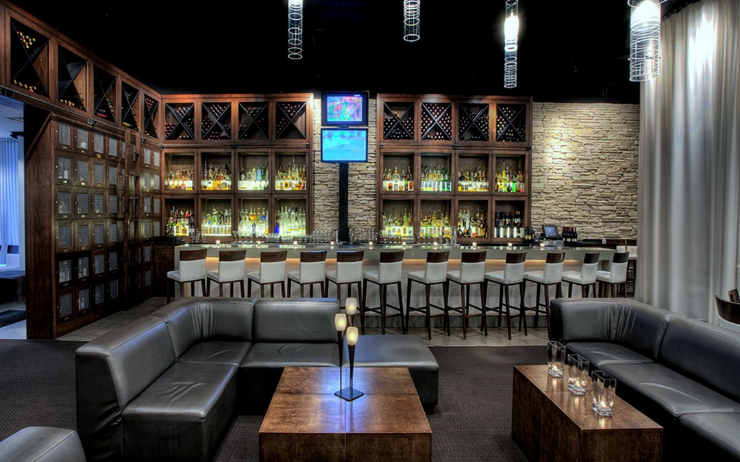 Custom wine lockers with upholstered seating at bar area