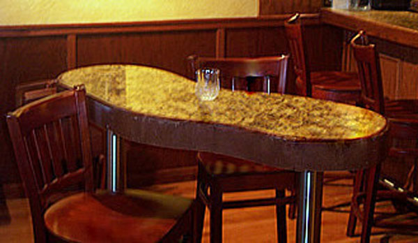 Irregular shaped high top drink table on stainless post